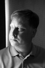 Obraz premium large portrait of an adult male blonde in a blue clothes, black and white image.