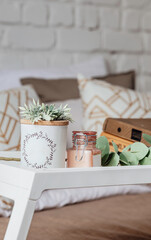 Books on a wooden table with a cup of coffee next to it. Working from home during coronavirus pandemic.