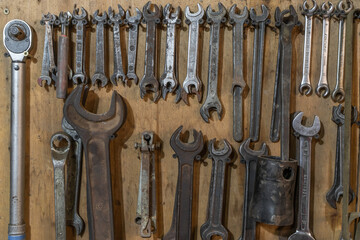 Set of wrenches tools hanging on a wall