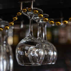 Wine glasses hanging over the bar. Soft focus