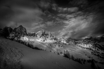 Beautiful black and white winter panorama on dolomite Rocchette Ridge with the slopes below abundantly covered of snow. San Vito di Cadore, Dolomites, Italy