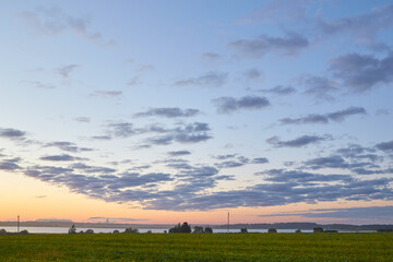 Obraz premium sunrise over a reservoir with a potash factory in the background
