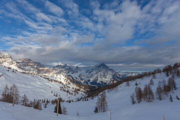 Fototapeta premium Winter sunset panorama with cloudy sky on Mount Sorapiss and Mount Antelao. San Vito di Cadore, Dolomites, Italy