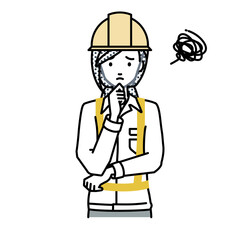 Fototapeta premium 立って手をあごにあてて困っている工事現場の女性