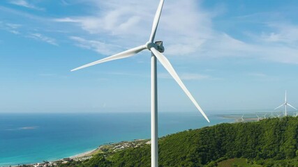 Wind turbine windmill in a field on the Caribbean Sea in the Dominican Republic. Green energy on a tropical island in a third world country.