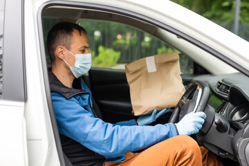 Delivery driver driving with parcels on seat