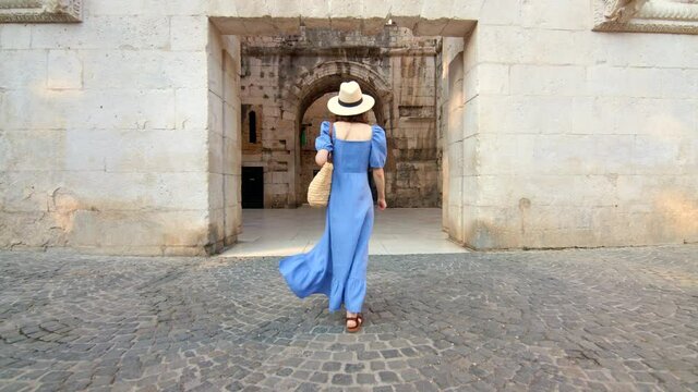 Young woman walking on the street in the city. Split, Croatia, video 6k