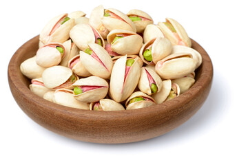 pistachios nuts in the wooden plate, isolated on white
