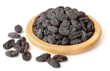 black raisins in the wooden bowl, isolated on white background