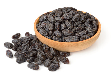 black raisins in the wooden bowl, isolated on white background