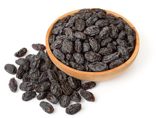 black raisins in the wooden bowl, isolated on white background