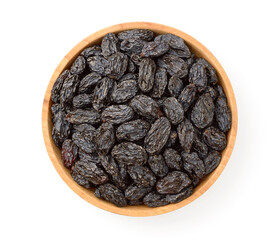 black raisins in the wooden bowl, isolated on white background, top view