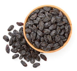 black raisins in the wooden bowl, isolated on white background, top view