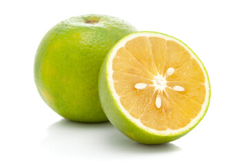 Close-up of Organic Indian Citrus fruit sweet limetta or mosambi (Citrus limetta) with its half cut, it is an green and yellow in color,  isolated over white background,