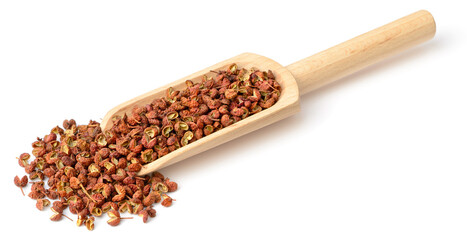 dried Sichuan peppercorns in the wooden scoop, isolated on the white background