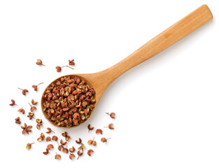 dried Szechuan pepper in the wooden spoon, isolated on the white background, top view