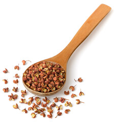 dried Szechuan pepper in the wooden spoon, isolated on the white background