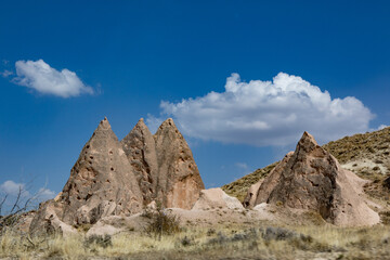Fototapeta premium Cappadocia, Turkey - September 1, 2021 – Impressive nature by chimney rock formations and rock pillars of “love Valley” near Goreme, Cappadocia, Nevsehir, Turkey