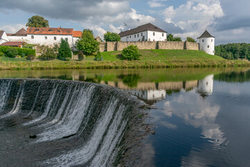 Fototapeta na wymiar Fortified village of Zumberk reflected in water. Southern Bohemia, Czech Republic