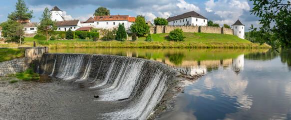 Fortified village of Zumberk reflected in water. Southern Bohemia, Czech Republic