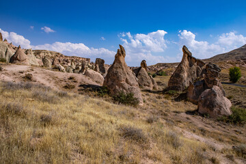 Fototapeta premium Cappadocia, Turkey - September 1, 2021 – Impressive nature by chimney rock formations and rock pillars of “love Valley” near Goreme, Cappadocia, Nevsehir, Turkey