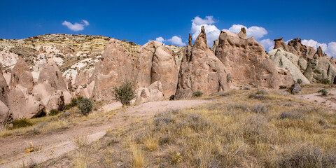 Fototapeta premium Cappadocia, Turkey - September 1, 2021 – Impressive nature by chimney rock formations and rock pillars of “love Valley” near Goreme, Cappadocia, Nevsehir, Turkey