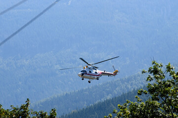 Fototapeta na wymiar Polish helicopter W-3WA Sokol lands in a mountain town Karpacz, Poland, September 2021