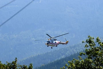 Zelfklevend Fotobehang Polish helicopter W-3WA Sokol lands in a mountain town Karpacz, Poland, September 2021 © vlamus