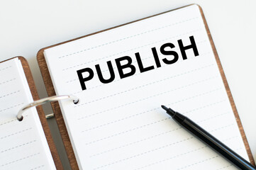 notepad with the text PUBLISH. Business concept