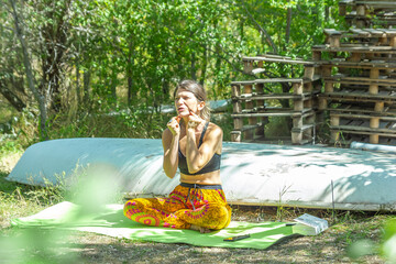 pretty young woman doing yoga in the park, woman doing exercise in the garden, yoga in the grass