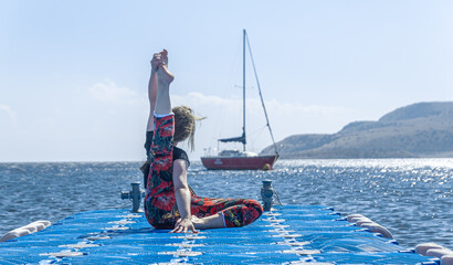 woman doing yoga exercise on the beach, woman relaxing on the beach, woman doing yoga