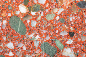 Natural stone background. A full-screen close-up texture of a red conglomerate (gravelite) with...