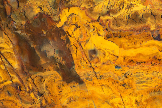 Full-screen close-up texture of yellow jasper stone.