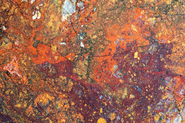 Full-screen texture of multicolored red-yellow jasper with blue chalcedony.