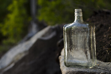 old clear bottle on nature background, parc régional seigneurie de la matapédia, québec, canada