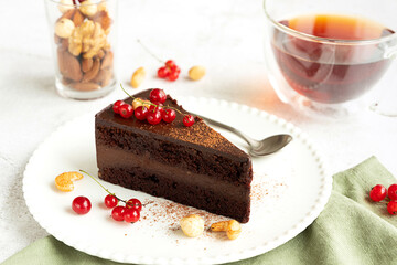 Raw vegan chocolate cake on light grey background