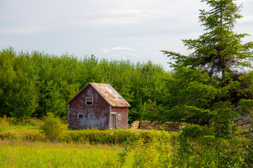 Old barn on a farm in the canadian countryside in Quebec	