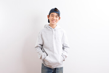 Young high school teen boy with hooded standing on white background.