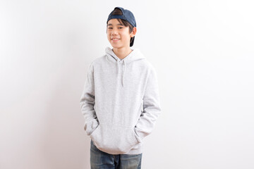 Young high school teen boy with hooded standing on white background.