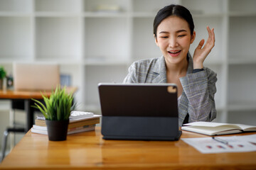 Portrait of Asian young Business woman in having a video call on laptop.