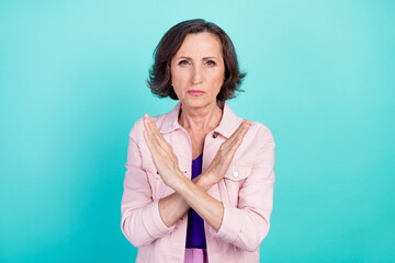 Photo portrait woman in casual clothes showing protest crossed hands isolated bright turquoise color background