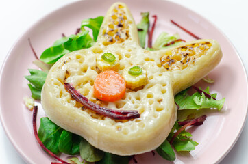 Funny and nice bunny shaped crumpets served with mix fresh vegetables, funny food for kids