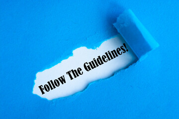 Follow The Guidelines word written under blue torn paper