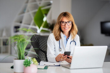 Female doctor using laptop while working at doctor's office
