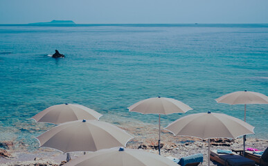 Fototapeta na wymiar Tranquil view to Dhermi beach turquoise water and umbrellas. Summer holiday vacation travel destination in Albania