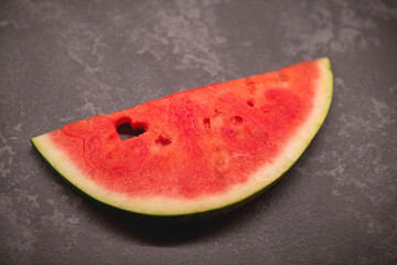 a slice of watermelon with a heart-shaped hole