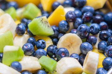 Fruit salad with fresh blueberries, bananas, kiwi and mango
