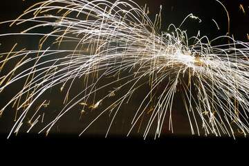 Sparks of small colored light flashes falling in the form of mountains at night. Concept:...