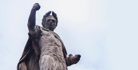 Antique statue of Roman dictator, politician, historian and military  general Gaius Julius Caesar. Copy space. - obrazy, fototapety, plakaty