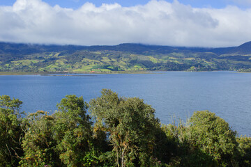 Fototapeta na wymiar Blue lagoon with trees and clouds, colombian mountains, laguna de la cocha